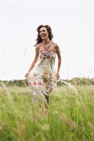 energetic fashion female - Woman running through wild meadow Stock Photo - Premium Royalty-Free, Code: 649-03621767