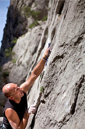 simsearch:649-05555429,k - Rock climber securing himself Stock Photo - Premium Royalty-Free, Code: 649-03622059