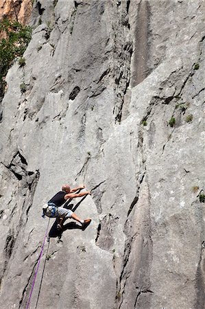 simsearch:649-05555429,k - Rock climber climbing rock face Stock Photo - Premium Royalty-Free, Code: 649-03622051