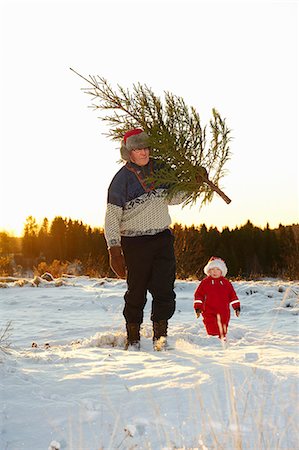 snow christmas tree white - Man and boy with Christmas tree in snow Stock Photo - Premium Royalty-Free, Code: 649-03666502