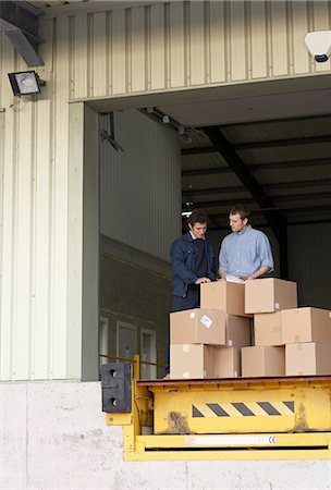 Businessman and worker in warehouse Stock Photo - Premium Royalty-Free, Code: 649-03667192