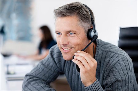 Businessman phoning with headset Stock Photo - Premium Royalty-Free, Code: 649-03769138