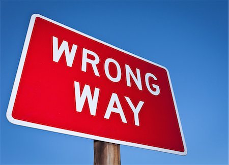 Wrong way sign against blue sky Stock Photo - Premium Royalty-Free, Code: 649-03769440