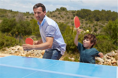 Father and son playing table tennis Stock Photo - Premium Royalty-Free, Code: 649-03769604