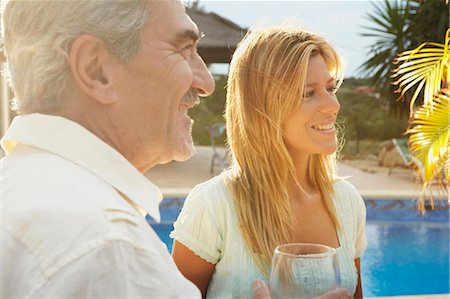 Smiling man and woman by poolside Stock Photo - Premium Royalty-Free, Code: 649-03769624