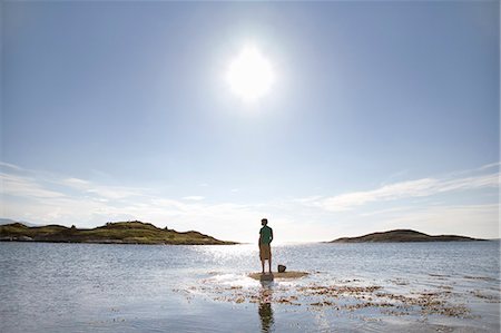 stranded - Man standing on rock in sea Stock Photo - Premium Royalty-Free, Code: 649-03769650