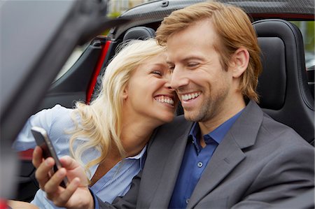 Couple in their electric sports car, fun Stock Photo - Premium Royalty-Free, Code: 649-03769962