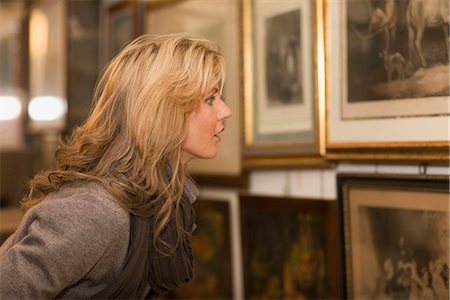 store historical - Woman looking up to painting Stock Photo - Premium Royalty-Free, Code: 649-03774772