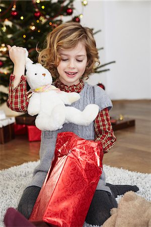 Girl putting bunny out of present Stock Photo - Premium Royalty-Free, Code: 649-03774862