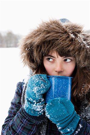 Girl sipping hot drink Stock Photo - Premium Royalty-Free, Code: 649-03774907