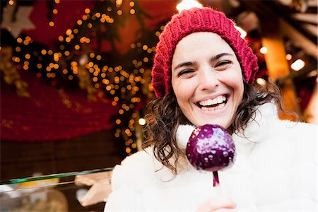 Woman holding candied apple Stock Photo - Premium Royalty-Free, Code: 649-03774939