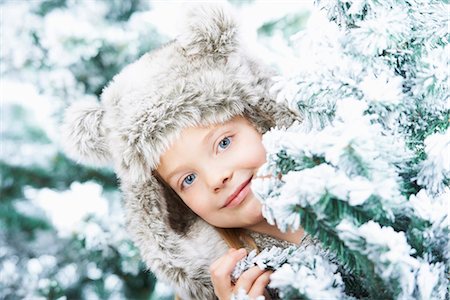 Girl standing between snowy trees Stock Photo - Premium Royalty-Free, Code: 649-03775085