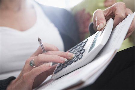 Close-up of woman's hands on calculator Stock Photo - Premium Royalty-Free, Code: 649-03770419