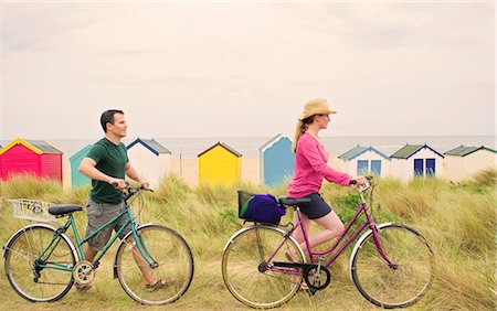 female and bike and beach - Couple push bicycles over beach Stock Photo - Premium Royalty-Free, Code: 649-03770566