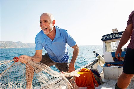 Fishermen pulling in nets Stock Photo - Premium Royalty-Free, Code: 649-03770741