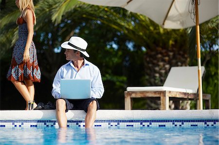 sitting poolside - Business Villa Stock Photo - Premium Royalty-Free, Code: 649-03770919