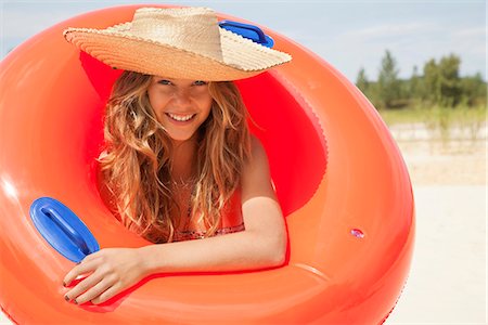 Pretty woman smiling with buoyancy ring Stock Photo - Premium Royalty-Free, Code: 649-03771209