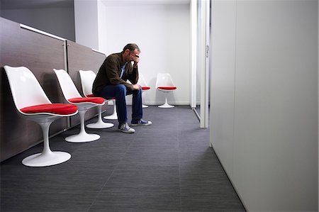 person overwhelmed stresss - Man sitting in a doctor's waiting room Stock Photo - Premium Royalty-Free, Code: 649-03771563