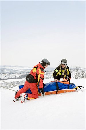 Two Rescuers helping skier Stock Photo - Premium Royalty-Free, Code: 649-03772090