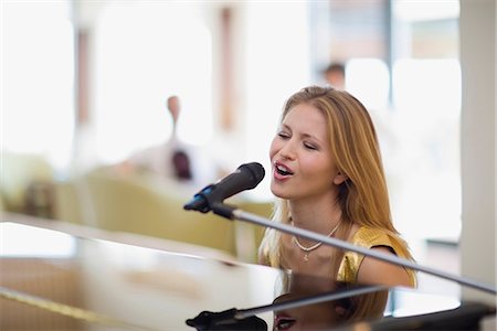 Girl singing and playing piano Stock Photo - Premium Royalty-Free, Code: 649-03772953
