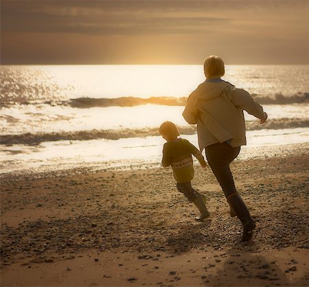 simsearch:649-06352471,k - Woman chasing young boy on beach. Autumn Stock Photo - Premium Royalty-Free, Code: 649-03773188