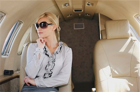 seated on airplane - Luxury shopper in personal jet Stock Photo - Premium Royalty-Free, Code: 649-03773326