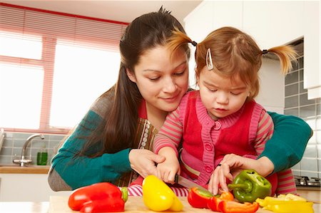 Mother and daughter chopping vegetables Stock Photo - Premium Royalty-Free, Code: 649-03796107
