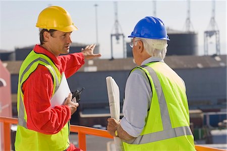 Two harbour workers talking about work Stock Photo - Premium Royalty-Free, Code: 649-03796294