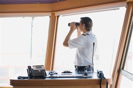 ship - Officer looking through binoculars Stock Photo - Premium Royalty-Free, Code: 649-03796353