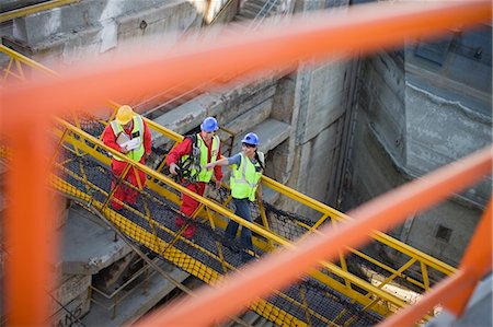 People crossing a bridge in a dockyard Stock Photo - Premium Royalty-Free, Code: 649-03796384