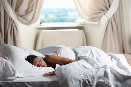 simsearch:649-06622033,k - Woman sleeping in bed, by the window Stock Photo - Premium Royalty-Free, Code: 649-03796588