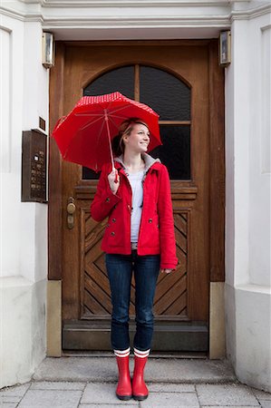 front stoop - Woman with umbrella in front of house Stock Photo - Premium Royalty-Free, Code: 649-03797129