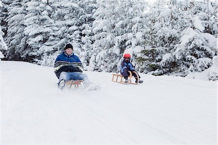 family fun in hill - Man and boy sledding downhill Stock Photo - Premium Royalty-Free, Code: 649-03797449