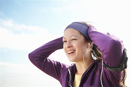 Woman in sports clothes smiling outside Stock Photo - Premium Royalty-Free, Code: 649-03816943