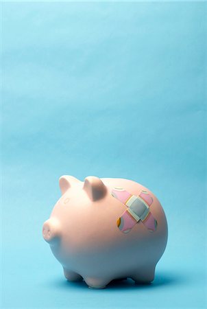 Piggy bank with plaster on it Stock Photo - Premium Royalty-Free, Code: 649-03818005