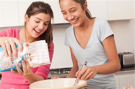 fun with flour - teenage girls preparing food in kitchen Stock Photo - Premium Royalty-Free, Code: 649-03818446