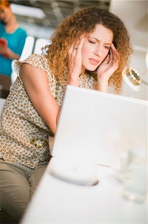 Frustrated businesswoman using laptop Stock Photo - Premium Royalty-Free, Code: 649-03857193