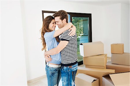 simsearch:649-03447245,k - Couple hugging in new home Stock Photo - Premium Royalty-Free, Code: 649-03857338