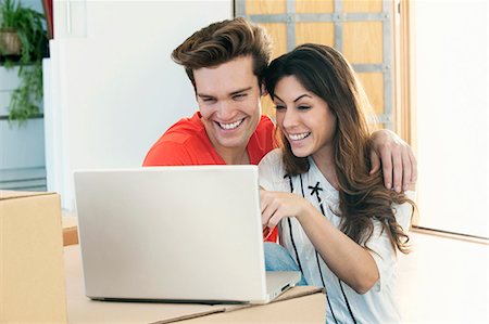simsearch:6113-06753677,k - Smiling couple using laptop together Stock Photo - Premium Royalty-Free, Code: 649-03857341