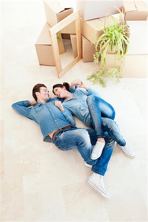 simsearch:649-03447245,k - Laughing couple laying on floor together Stock Photo - Premium Royalty-Free, Code: 649-03857365