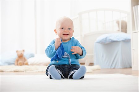 Baby boy playing with soft toy Stock Photo - Premium Royalty-Free, Code: 649-03857375