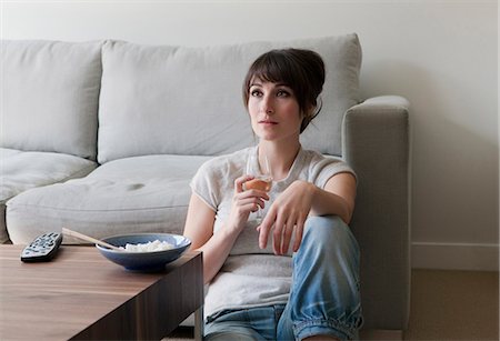 Woman watching television with dinner Stock Photo - Premium Royalty-Free, Code: 649-03857412