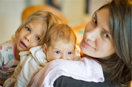 simsearch:649-05950793,k - Woman smiling with daughters Stock Photo - Premium Royalty-Free, Code: 649-03857600