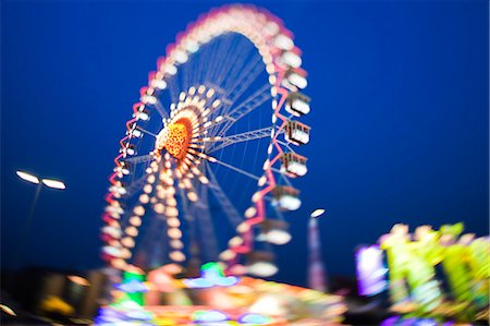 entertainment and amusement park - Ferris wheel lit up against night sky Stock Photo - Premium Royalty-Free, Code: 649-03857636