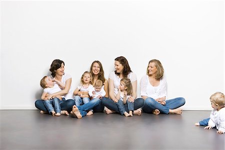 family white background full body - Mothers and children sitting together Stock Photo - Premium Royalty-Free, Code: 649-03857902