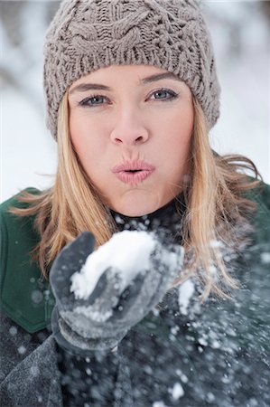 snow ball - Woman blowing handful of snow Stock Photo - Premium Royalty-Free, Code: 649-03858252