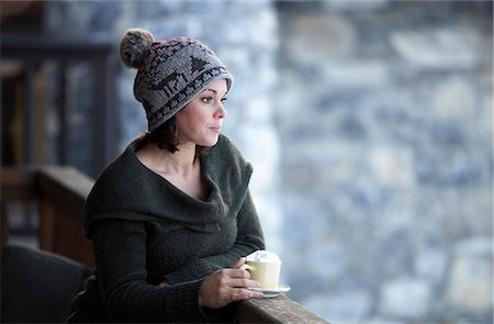 Woman with hot drink on chalet balcony Stock Photo - Premium Royalty-Free, Code: 649-03858364