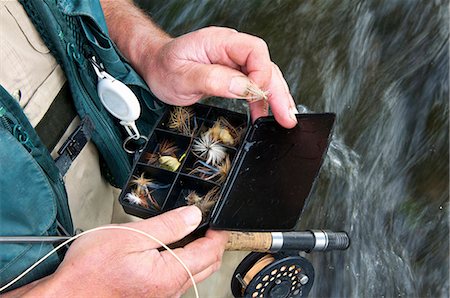 selection - Fly fisherman holding fly box in river Stock Photo - Premium Royalty-Free, Code: 649-03858375