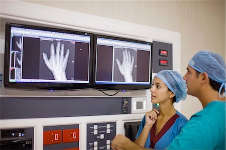 Doctors examining x-ray of hand Stock Photo - Premium Royalty-Free, Code: 649-03881665