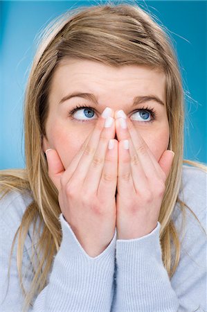 suspicious - Girl covering her mouth with hands Stock Photo - Premium Royalty-Free, Code: 649-03881826